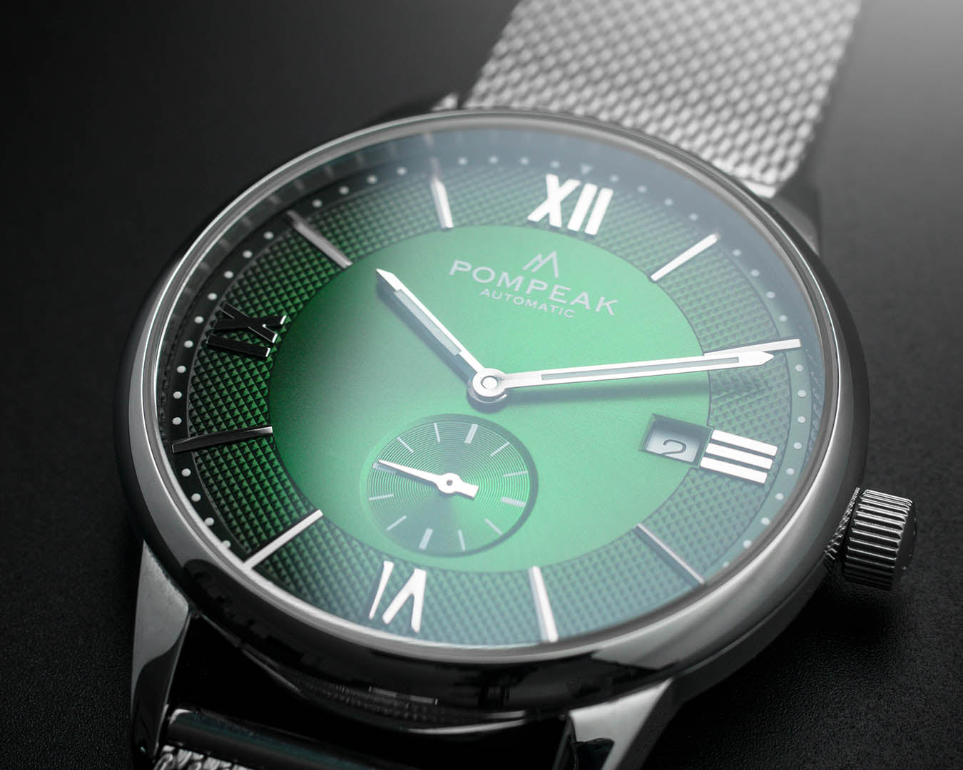 Full view of the Mallory British Racing Green watch, showing its 40mm stainless steel case, solid sapphire crystal, signed crown, and fumé green dial.