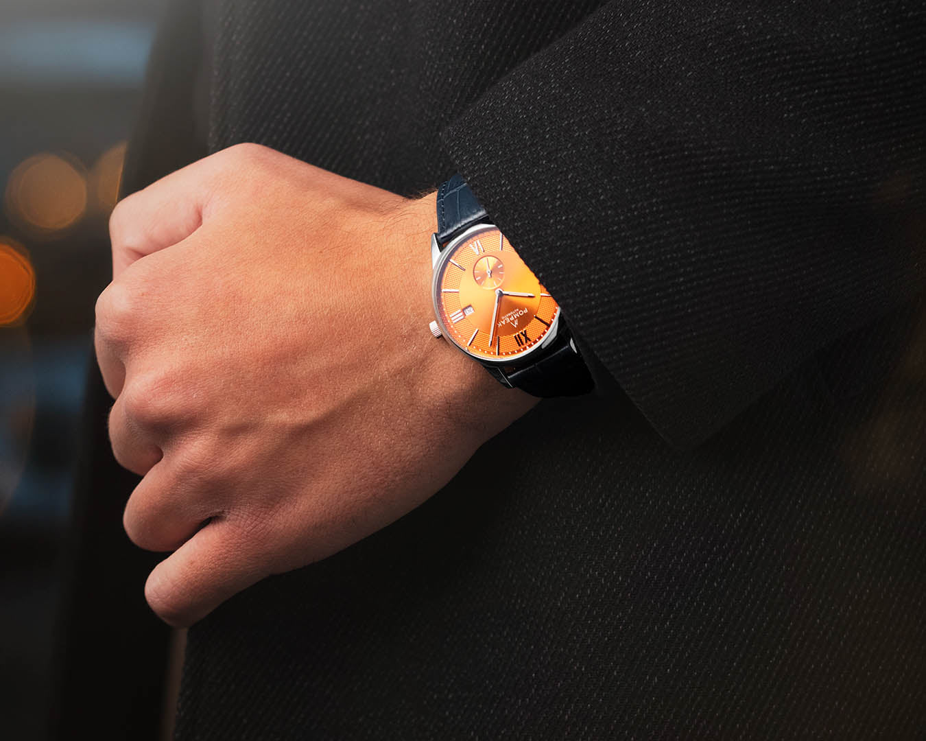 Mallory Orange Crush Swiss automatic dress watch worn on the wrist with a blue mock croc leather strap, showcasing its striking design and comfortable fit.