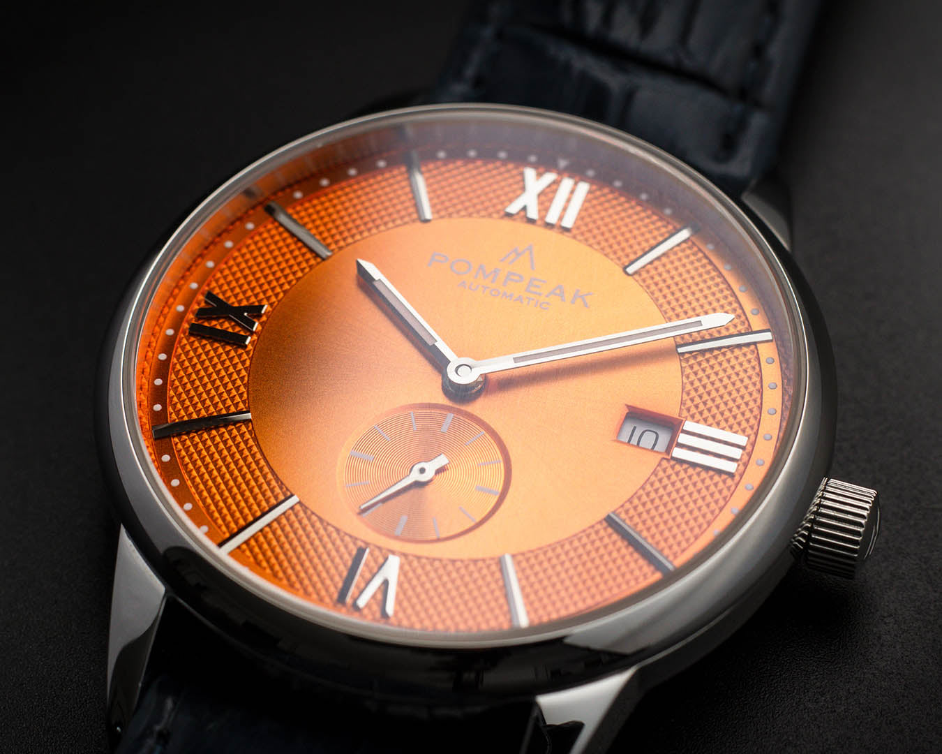 Full view of the Mallory Orange Crush watch, displaying its 40mm stainless steel case, solid sapphire crystal, dial, and signed crown.