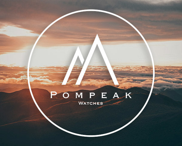 Pompeak Watches Logo Over Sunset Mountain