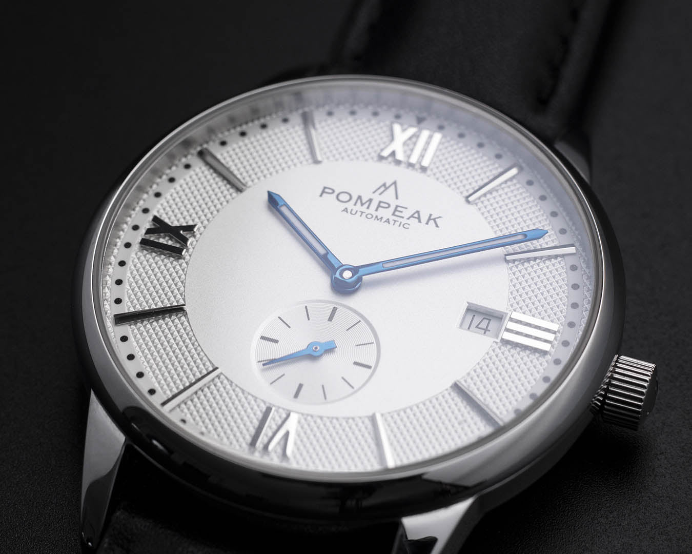 Full view of the Mallory Timeless White watch, displaying its 40mm stainless steel case, anti reflective sapphire crystal, dial, and signed crown.