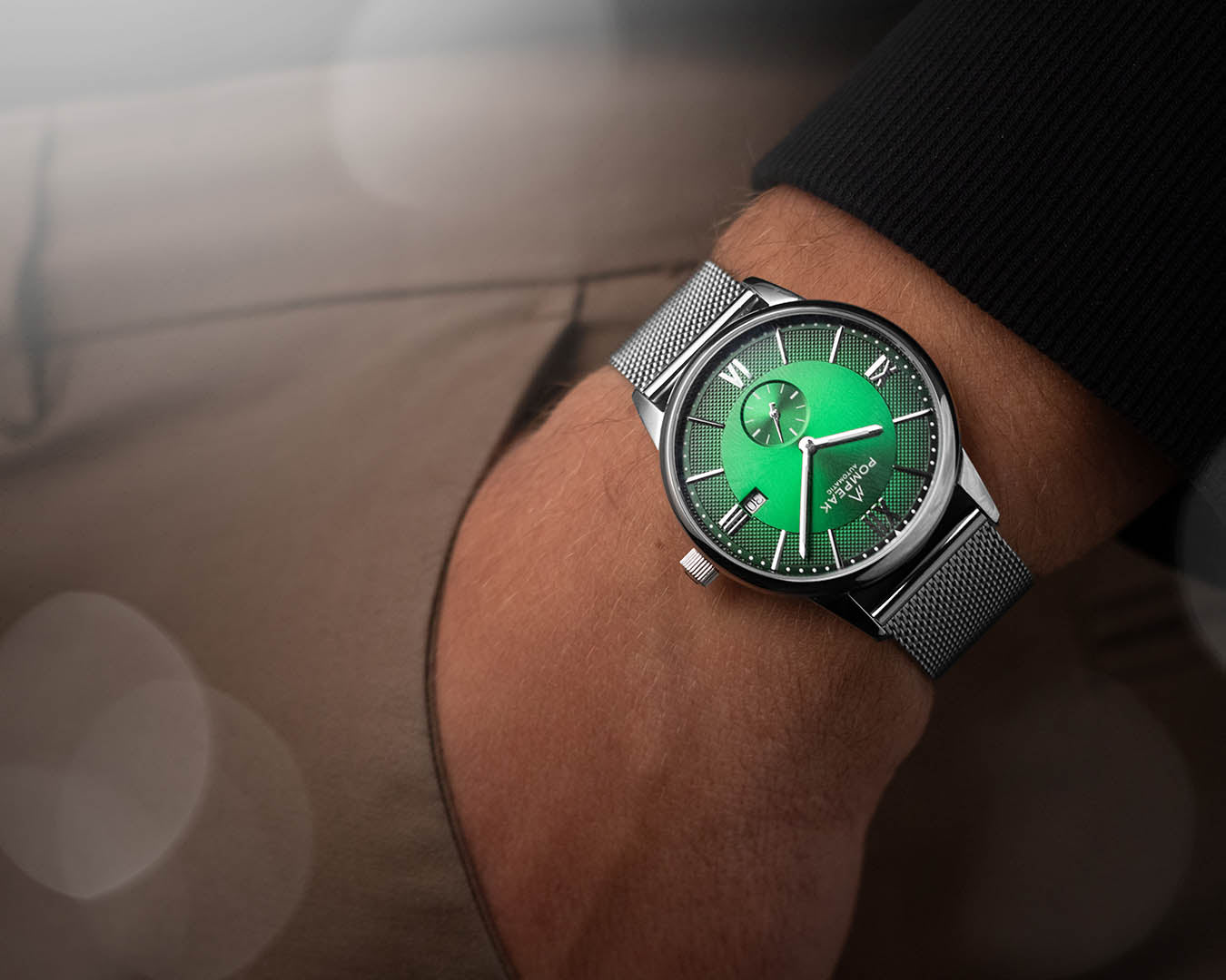 Mallory British Racing Green dress watch worn on a stainless steel Milanese mesh strap, offering a refined and contemporary look.