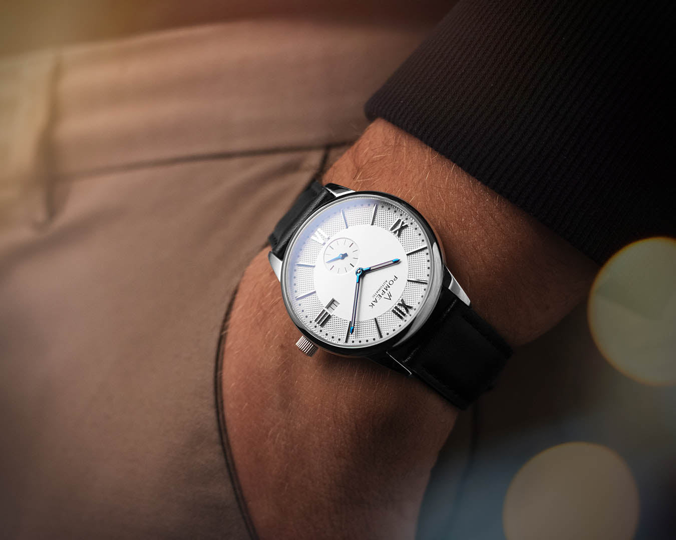 Mallory Timeless White dress watch worn on the wrist with a black leather strap, showcasing its elegant proportions and refined design.