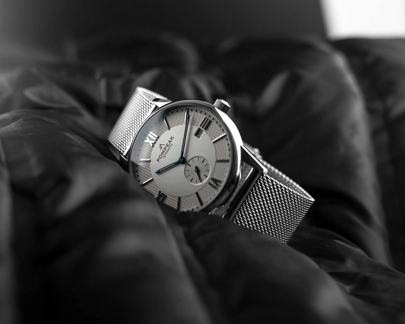 Mallory Timeless White Swiss automatic watch on a 316L stainless steel Milanese mesh strap for a sleek, modern look.