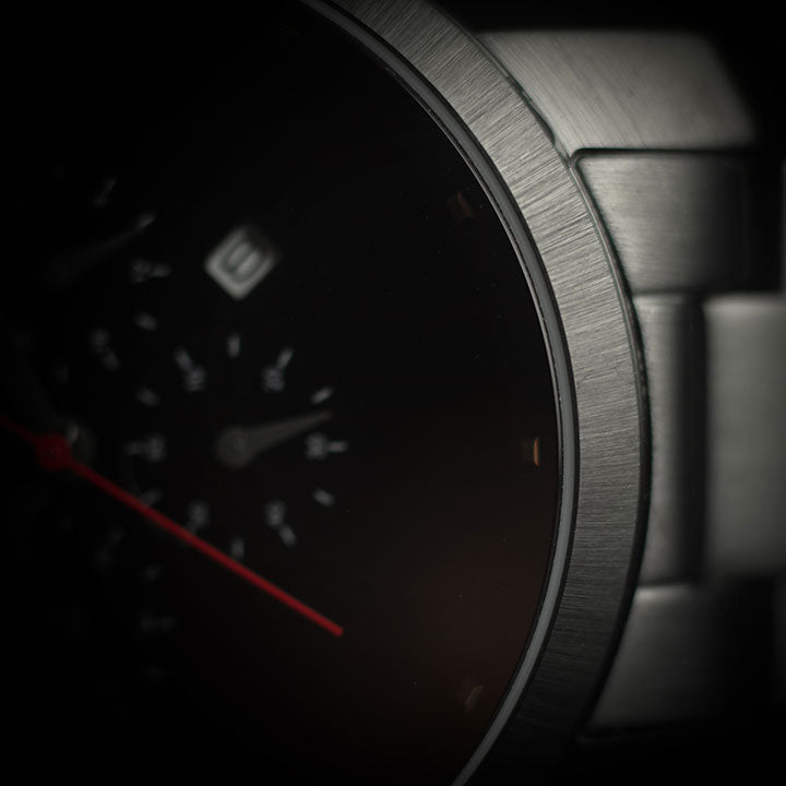 Pompeak Debut Metallic Black Chronograph Watch Dial with Red Hand Macro Photography
