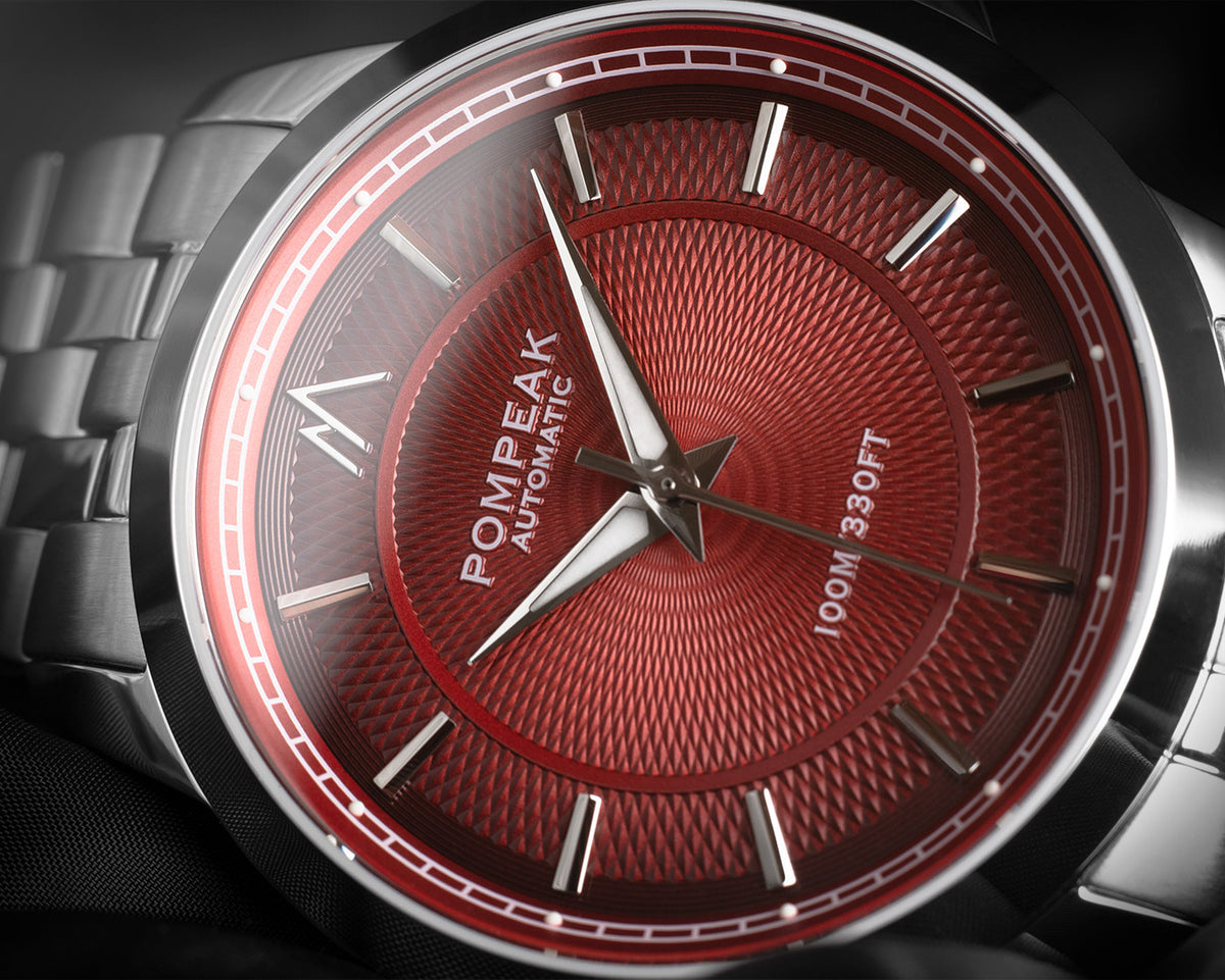Close-up of a Pompeak Red Fume Guilloche dial.